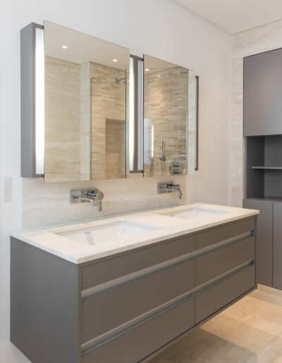 Floating double vanity unit with Travertine Bianco worktop and wall mounted taps London