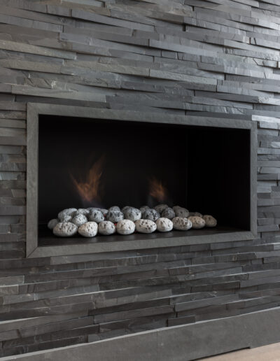Bespoke green slate fireplace with slate mosaic wall in luxury London home