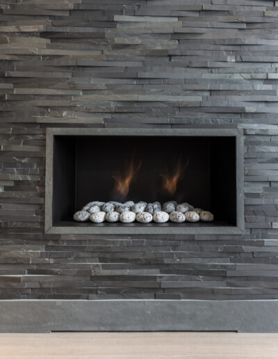 Luxury green slate fireplace detail with natural stone surround Hill Gate London