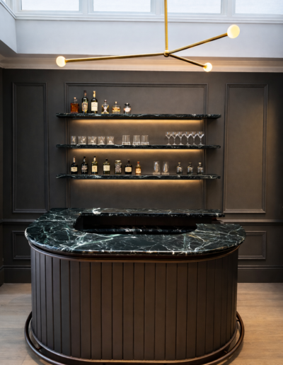 Bespoke Verde Alpi marble home bar with curved marble countertop in Westbourne Terrace London project