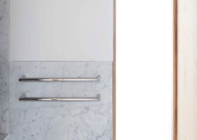 Carrara marble wall cladding and bespoke bathroom detail in Marylebone London by Marble Bros LTD